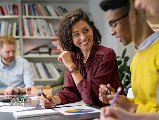 two people working at a table smiling
